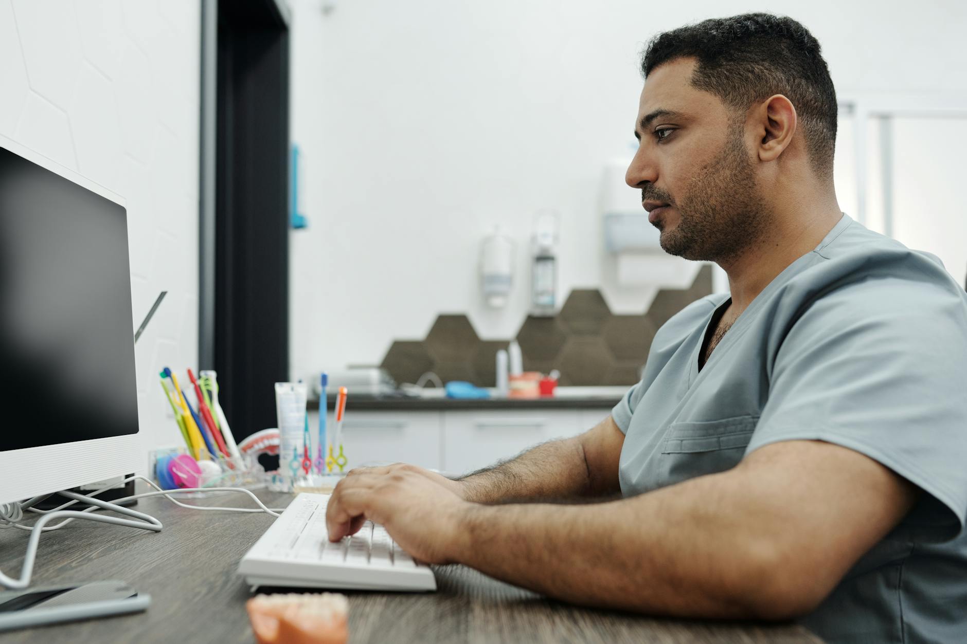 Dental professional working on a computer