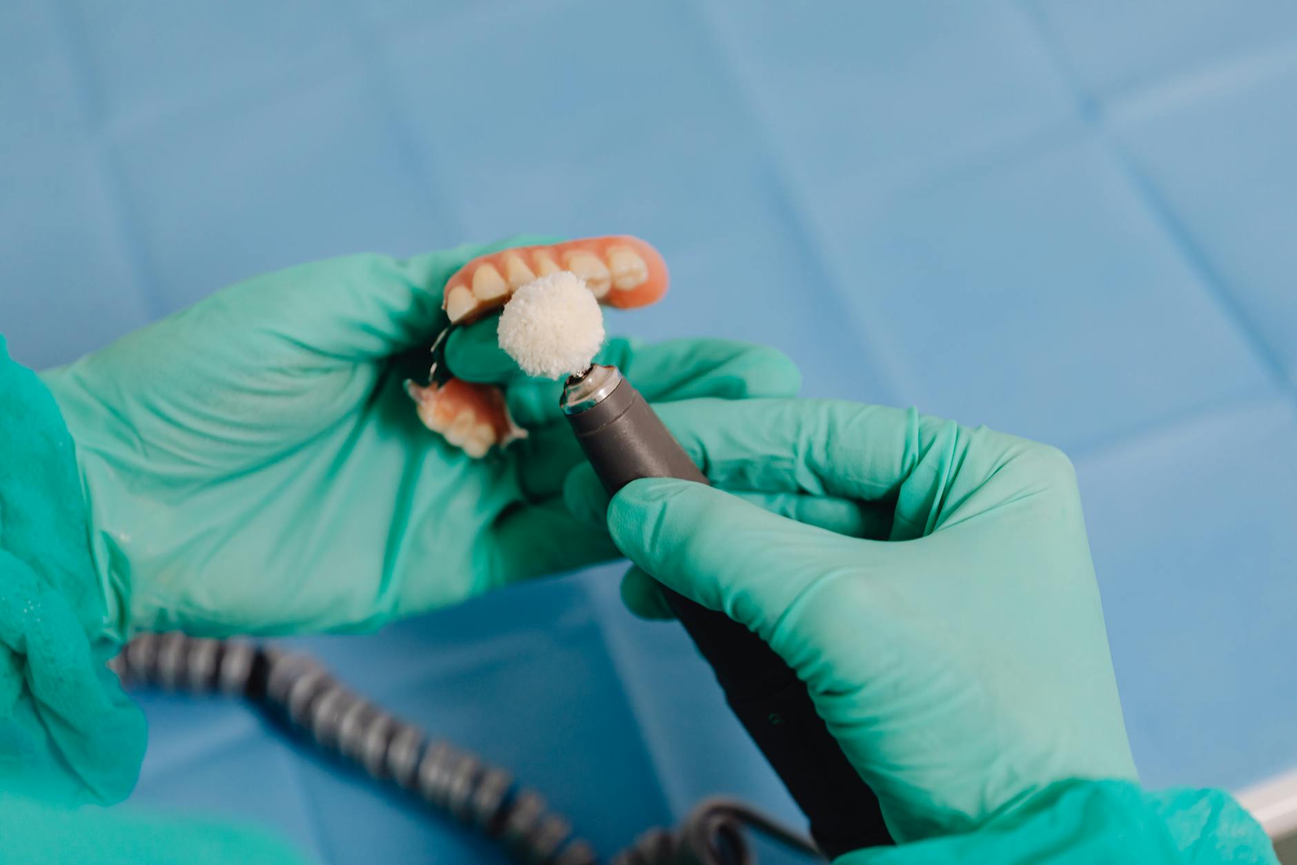 Dental technician polishing a restoration