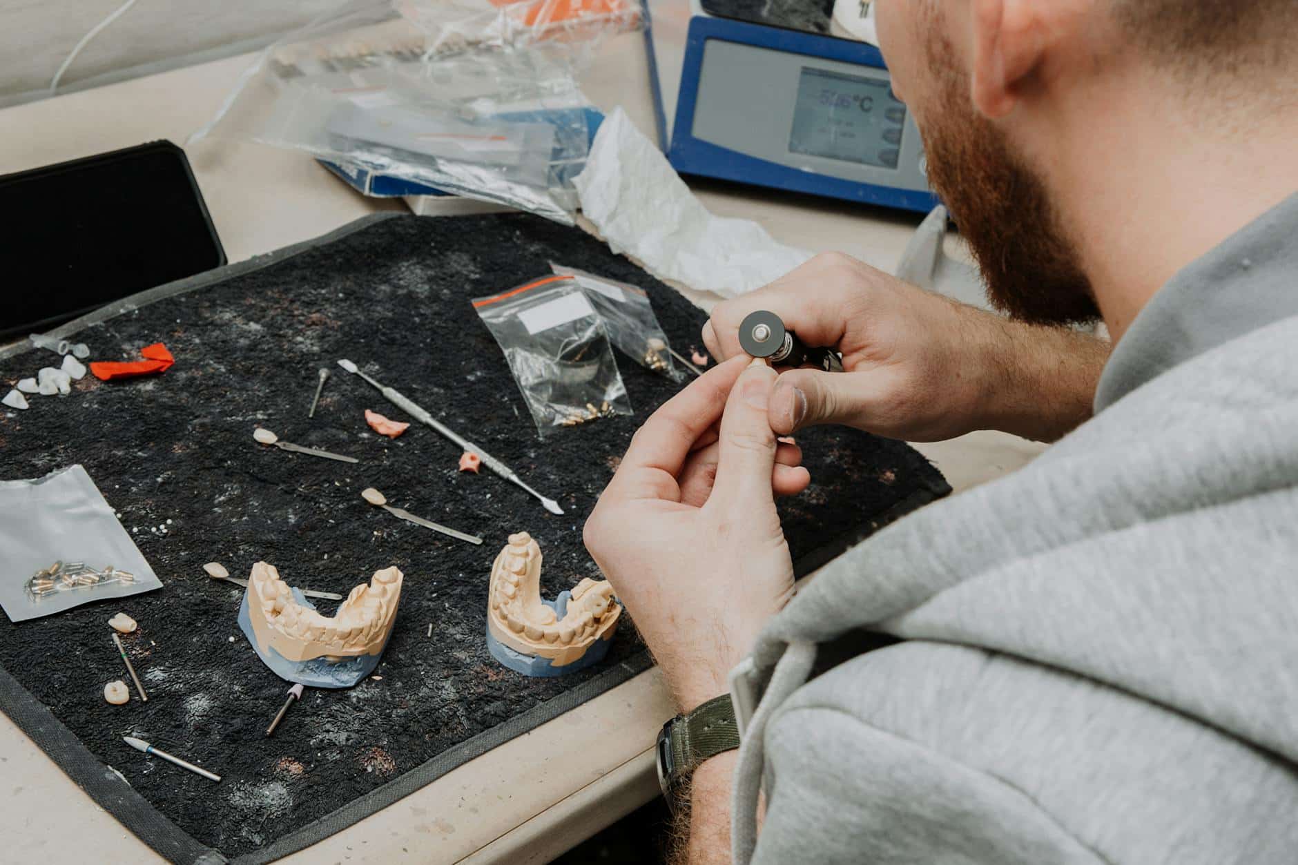 Dental technician working with dental impression